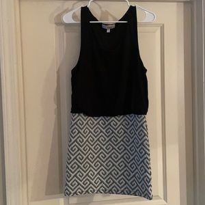 Dress with black top and gray white patterned skirt.